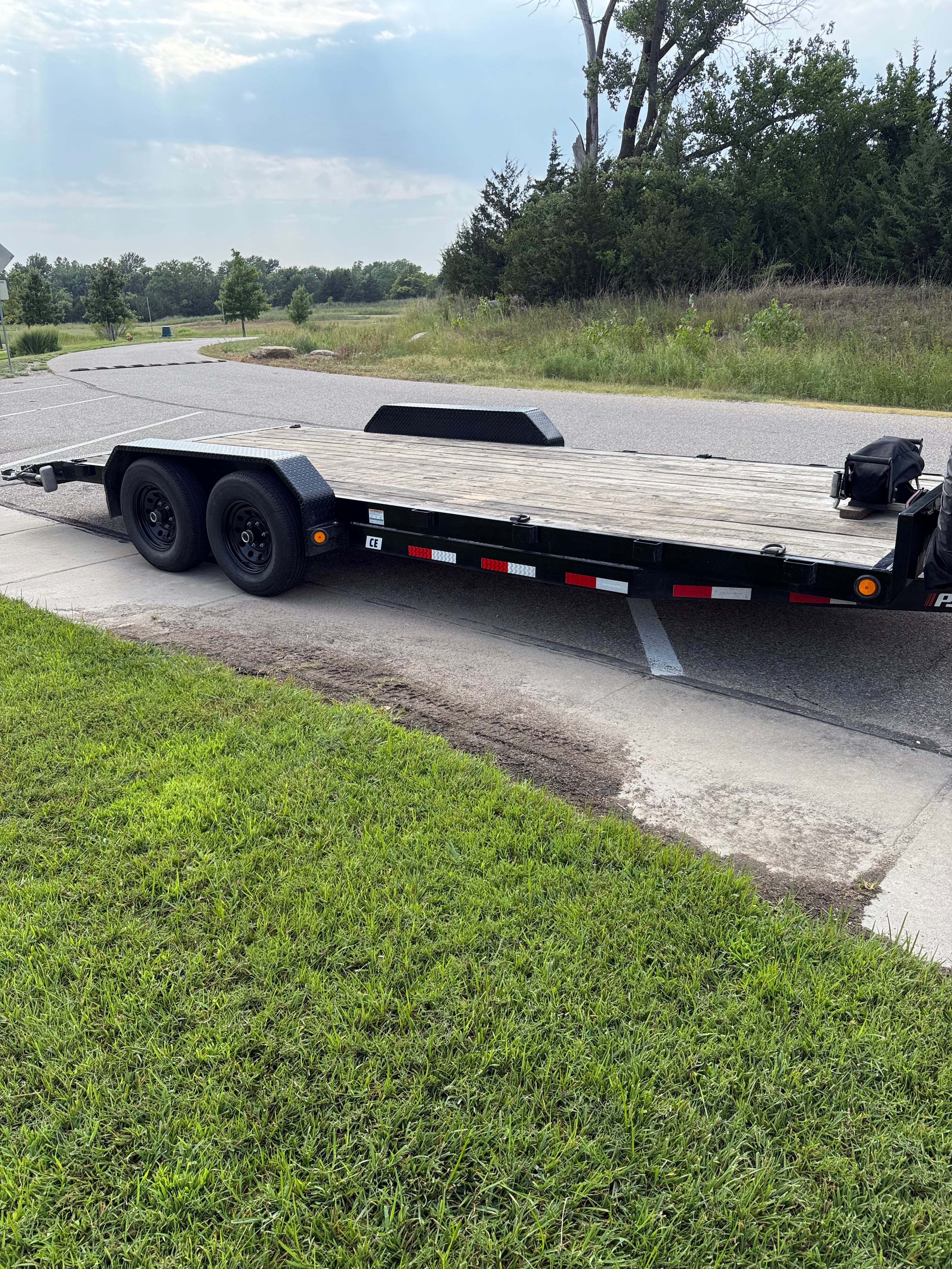 PJ CE202 car hauler trailer full side profile showing wooden deck and dual axle for rent in Hutchinson Kansas